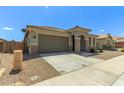 Attractive home featuring desert landscaping and a convenient two-car garage at 17219 W Gibson Ln, Goodyear, AZ 85338
