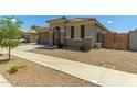 Inviting single-Gathering house with a well-kept yard and attached garage at 17219 W Gibson Ln, Goodyear, AZ 85338