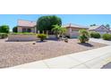 Inviting single-story home with a two-car garage and easy to maintain desert landscaping at 17371 N Natura Trl, Surprise, AZ 85374