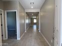 Bright hallway with tile flooring leads to various rooms, showcasing the home's layout and spaciousness at 17482 W Fulton St, Goodyear, AZ 85338