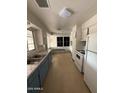 Functional kitchen with ample storage, classic appliances, and bright natural light at 1807 W Hazelwood St, Phoenix, AZ 85015