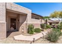 Inviting front entrance with a security door, well-kept landscape, and a brick-lined walkway at 20307 N Painted Sky Dr, Surprise, AZ 85374