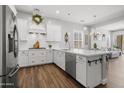 Well-lit kitchen featuring quartz countertops, stainless steel appliances, and wood flooring at 20607 W Point Ridge Rd, Buckeye, AZ 85396