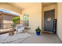 Inviting front porch with comfortable seating, decorative plants, and a welcoming entrance with a 'Welcome' sign at 20607 W Point Ridge Rd, Buckeye, AZ 85396
