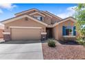 Attractive two-story home with a two-car garage, desert landscaping, and blue shutters at 23955 W La Salle St, Buckeye, AZ 85326