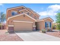 Two-story home with a two-car garage, desert landscaping, and a well-maintained lawn at 23955 W La Salle St, Buckeye, AZ 85326