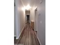 Bright hallway with wood-look floors and neutral paint leads to other rooms at 2400 E Baseline Ave # 144, Apache Junction, AZ 85119