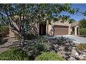Home featuring a desert landscape, inviting front entrance, with a two-car garage at 26725 W Marco Polo Rd, Buckeye, AZ 85396