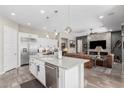 Open concept kitchen featuring a large island, stainless steel appliances, and views into the living area at 2835 E Donald Dr, Phoenix, AZ 85050