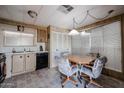 The kitchen includes a dining area, appliances, wood cabinets, and a window for natural light at 303 S Recker Rd # 29, Mesa, AZ 85206