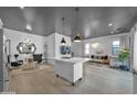 Bright open-concept living room showcasing a kitchen island, hardwood floors, and stylish furnishings at 3136 E Cheryl Dr, Phoenix, AZ 85028