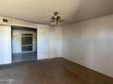 Empty living room featuring a ceiling fan and sliding glass door at 3719 W Thunderbird Rd, Phoenix, AZ 85053