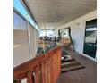 Covered porch features a cozy seating area with a swing and sliding door access to the home at 4065 E University Dr # 240, Mesa, AZ 85205