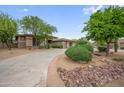 Charming single-story home with mature trees and a well-manicured circular driveway at 4684 E Coachwhip Rd, Cave Creek, AZ 85331