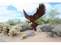 Impressive metal owl sculpture displayed prominently in the landscaped front yard at 4684 E Coachwhip Rd, Cave Creek, AZ 85331