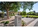 Inviting exterior view of a home featuring lush landscaping, a paver driveway, and a charming mailbox at 6997 E Paradise Ranch Rd, Paradise Valley, AZ 85253