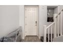 Entryway featuring a white front door, tiled floors, stairs, and decorative niche at 706 E Washington St # 207, Phoenix, AZ 85034