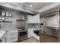Modern kitchen with stainless steel appliances and white cabinetry at 706 E Washington St # 207, Phoenix, AZ 85034