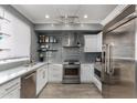 Stylish kitchen featuring stainless steel appliances and sleek gray subway tile backsplash at 706 E Washington St # 207, Phoenix, AZ 85034
