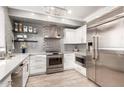 Modern kitchen with stainless steel appliances, white cabinetry, and attractive backsplash and countertops at 706 E Washington St # 207, Phoenix, AZ 85034