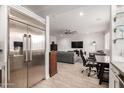View of the living room from kitchen showing tiled floors, natural lighting and a contemporary design at 706 E Washington St # 207, Phoenix, AZ 85034