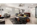 Cozy living room with a ceiling fan, natural light, tiled floors and a sofa with decorative pillows at 706 E Washington St # 207, Phoenix, AZ 85034
