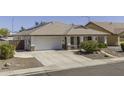 Charming single-story home featuring desert landscaping, tile roof, covered porch, and two-car garage at 7832 E Osage Ave, Mesa, AZ 85212