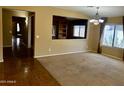 Bright living room featuring large windows, neutral carpeting, and an open layout for easy flow at 830 E Dry Creek Rd, San Tan Valley, AZ 85143