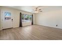 Bright living room featuring new flooring, a ceiling fan, and natural light at 8725 E Coronado Rd, Scottsdale, AZ 85257