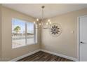Dining area with stylish chandelier, modern decor, and a large window for ample natural light at 9625 W Mountain View Rd # A, Peoria, AZ 85345