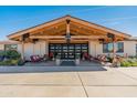 Inviting entrance with a striking wooden beam design, comfortable seating, and tasteful landscaping at 11119 W Mountain View Rd, Sun City, AZ 85351