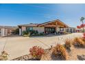 Charming home exterior with a welcoming entrance, lush landscaping, and a spacious driveway at 11119 W Mountain View Rd, Sun City, AZ 85351