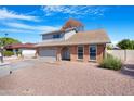 Two-story home showcasing brick accents, a two-car garage, and low maintenance landscaping at 1354 W Nido Ave, Mesa, AZ 85202