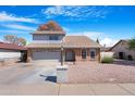 Beautiful home with a brick entryway, a two-car garage, and low maintenance landscaping at 1354 W Nido Ave, Mesa, AZ 85202