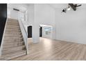 Bright living room with a soaring ceiling, wood flooring and a staircase at 1354 W Nido Ave, Mesa, AZ 85202