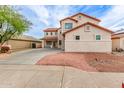View of the front yard with decorative rock and spacious driveway at 16215 W Durango St, Goodyear, AZ 85338