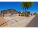 Well-maintained single-story home with a desert landscaped front yard on a sunny day at 16768 W Nottingham Way, Surprise, AZ 85374
