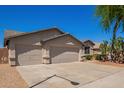 Attractive single-story home with a desert landscaped front yard, and a three-car garage at 16768 W Nottingham Way, Surprise, AZ 85374