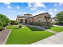 Charming home with verdant artificial turf, stone accents, and meticulous desert landscaping at 20759 W Meadowbrook Ave, Buckeye, AZ 85396