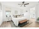 Comfortable bedroom with a large window, plush bedding, and a decorative bench at 3828 S 180Th Ln, Goodyear, AZ 85338