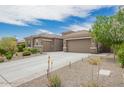 Gorgeous home with a 3-car garage, lush desert landscaping, and a spacious driveway at 44036 N Hudson Trl, New River, AZ 85087