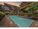 Community pool with plenty of lounge seating and shade is surrounded by the complex at 7131 E Rancho Vista Dr # 3001, Scottsdale, AZ 85251