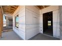 Unfinished new construction featuring a window and exterior door opening at 11423 E Utah Ave, Mesa, AZ 85212