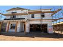 New construction home featuring unfinished exterior, scaffolding, and garage door opening at 11423 E Utah Ave, Mesa, AZ 85212