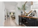 Welcoming entryway featuring decorative furnishings, a large mirror, and a view into the open-concept living spaces at 14114 W Surrey Dr, Surprise, AZ 85379