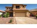 Charming two-story home featuring a spacious two-car garage, desert landscaping, and a tile roof at 14246 W Columbus Ave, Goodyear, AZ 85395