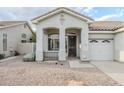 Inviting front entrance with an arched entryway, security door, and desert landscaping at 1584 E Harrison E St, Chandler, AZ 85225