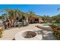 Entertainer's backyard featuring a firepit and patio area at 16753 W Bristol Ln, Surprise, AZ 85374
