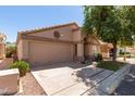 Well-kept single-story home featuring neutral paint and a two-car garage and xeriscape landscaping at 17119 N Joshua Path, Surprise, AZ 85374