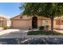 Inviting single-story home showcasing well-maintained landscaping, neutral tones, and an attached two-car garage at 17119 N Joshua Path, Surprise, AZ 85374